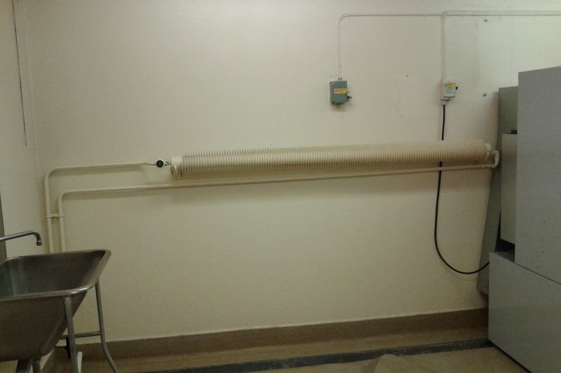 Favier radiator, a finned tube radiator, a pipe-shaped heating radiator with helical-shaped flange. In the basement of a building from 1946.